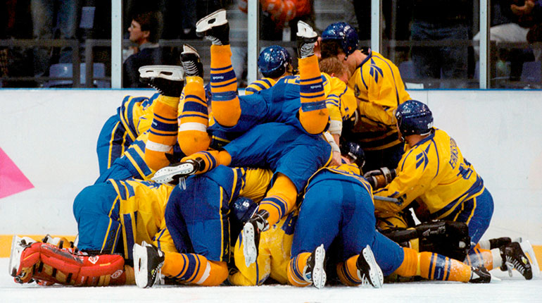 En hög av ishockeyspelare ovanpå varandra. 